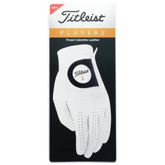 A white golf glove is displayed on a card packaging featuring the Titleist logo and brand name. It highlights "Finest Cabretta Leather" and indicates it's a new product.