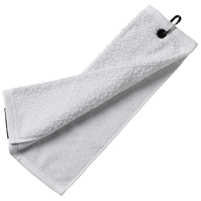 A white towel is hanging loosely and is slightly folded with a metal clip attached to one end resting against a flat surface providing a clean and functional appearance.