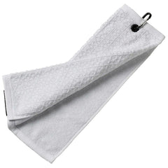 A white towel is hanging loosely and is slightly folded with a metal clip attached to one end resting against a flat surface providing a clean and functional appearance.