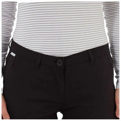A person is wearing a fitted striped long-sleeve top and black pants featuring a button closure and side pockets against a plain background.