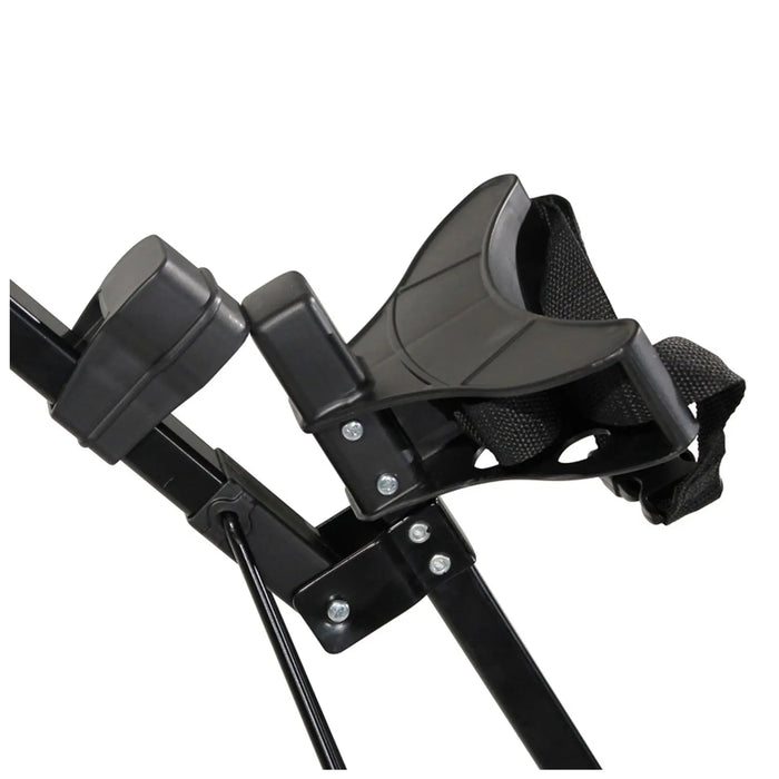 A black adjustable footrest with a strap is mounted on a metallic frame featuring screws and joints indicating an assembly for stability in a seating or exercise context.