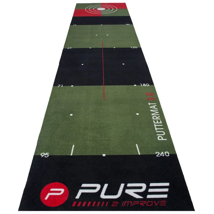 A long green putting mat is laid out with distance markers and targets at the far end showing a concentric circle design indicating practice areas for golf putting skills.