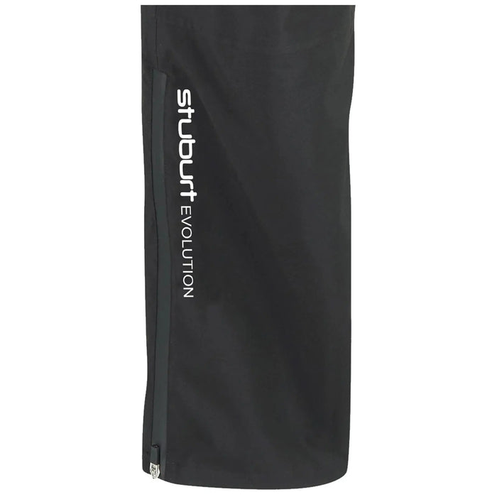 A black golf rain pant is displayed featuring a zippered pocket and the text "stuburt EVOLUTION" printed vertically in white on the side. The fabric appears smooth and functional for wet conditions.